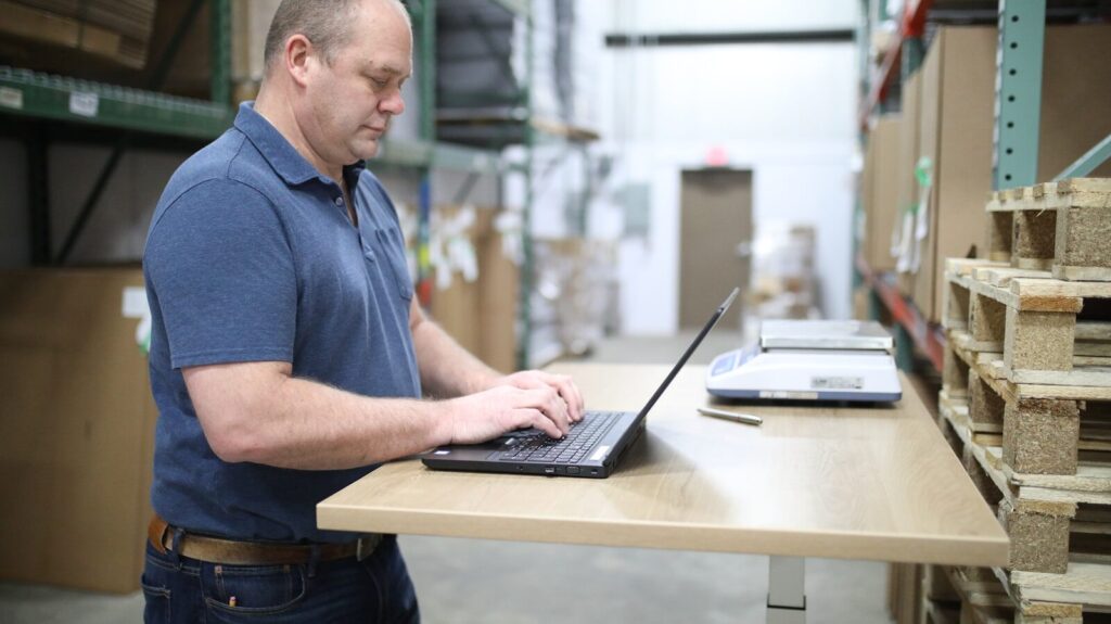 small business owner packing shipping boxes for logistics