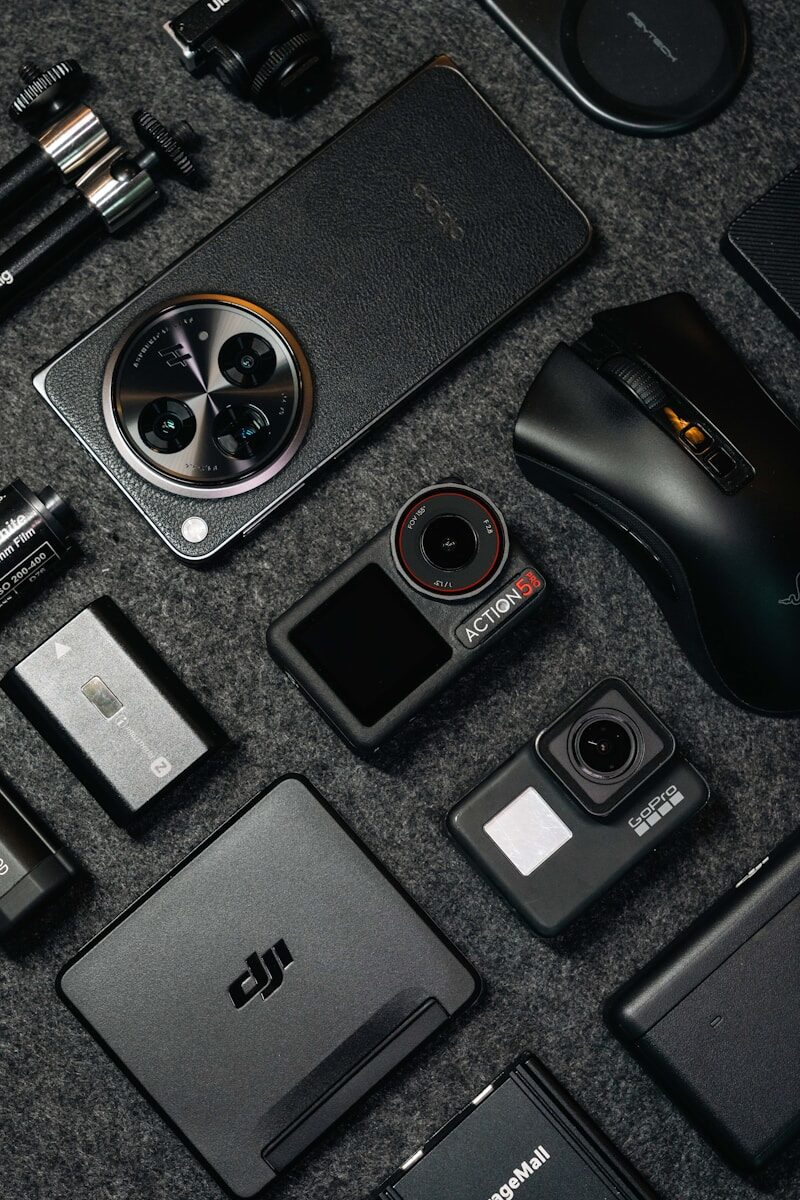 Tech gadgets and accessories arranged on a dark background.